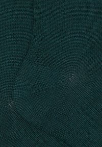 Calzini verdi scuro lavorati a maglia con un motivo strutturato e finitura liscia, con tallone e punta rinforzati per una maggiore durata.