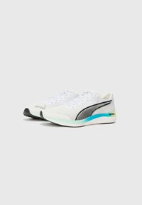 White athletic shoes with a streamlined design, black accents, mesh panels, and a turquoise sole featuring "NITRO" branding.