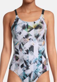 Eén stuk zwemoutfit met een geometrisch patroon in zwart, wit en pastelkleuren. Gemaakt van soepel, rekbaar materiaal. Dunne bandjes.