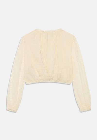 Μπλούζα σε κρεμ απόχρωση, κοντή, με μακριά μανίκια, υφασμένη ύλη με γεωμετρικό μοτίβο και σούρες στα μανίκια. Απαλή, ελαφριά υφή.