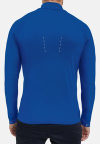 Koningsblauwe lange mouwen sportshirt met een gestructureerde afwerking. Kenmerkt zich door contrasterend witte stiksels op de achterkant en geribbelde manchetten.