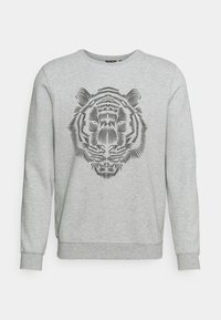 Felpa grigia con una grafica di testa di tigre nera stampata in un design lineare sulla parte anteriore. Presenta un collo rotondo e maniche lunghe.