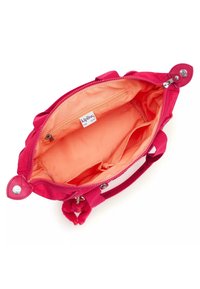 Pink fabric handbag with a zip closure, bright orange lining, one interior zip pocket, and two open pockets. Features a pom-pom accent.