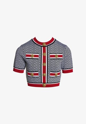Crop top à manches courtes noir et blanc à motifs avec bordure rouge et boutons décoratifs dorés à l'avant et sur les poches.