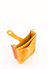 Oranger Leder- und Wildlederbeutel mit strukturiertem Finish, ausgestattet mit einem Druckknopfverschluss, einem goldenen Akzent und einer seitlichen Schlaufe zur Befestigung.