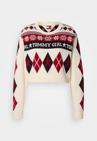 Krómpolt pulóver krém színben, piros és fekete gyémántmintával. Rugalmas szegéllyel, kerek nyakkal és "TOMMY GIRL" felirattal a mellkason.