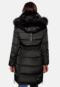 Black puffer jacket with a fur-trimmed hood, zippered pockets, textured finish, and elastic waistband, featuring a brand tag at the back.