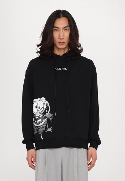 Sort hoodie med frontgrafik af en tegneseriefigur, snoretræk til hætten og ribbede manchetter. Fremstillet af blødt stof med en afslappet pasform.