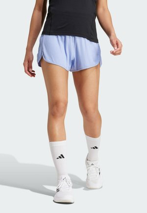 Light blue athletic shorts with vertical stripes and a curved hem, paired with white socks featuring a black logo and white sneakers.