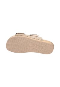 Beige clogs with two buckle straps, wooden sole, and textured rubber outsole featuring a wave pattern and brand name embossed.