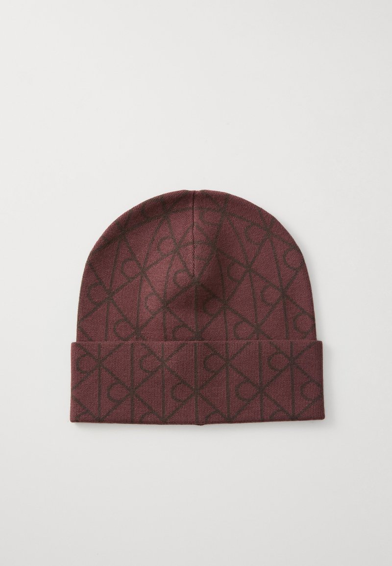 Maroon knit beanie with a folded cuff, featuring a geometric pattern in dark brown. Soft texture with a snug fit for warmth.