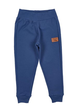 Marineblauwe sweatpants van zacht materiaal, met een geribbelde tailleband en boorden, en een klein bruin leren logo-opdruk aan de zijkant.