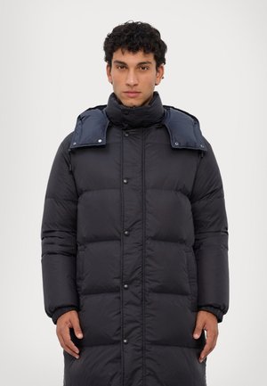 Black puffer coat with a mid-length design, snap buttons, high collar, and contrasting blue detachable hood. Smooth, padded texture.