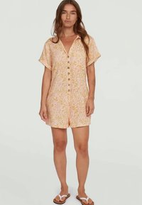 Short-sleeve romper in light orange fabric with floral pattern, featuring a button front and a relaxed fit with short shorts.