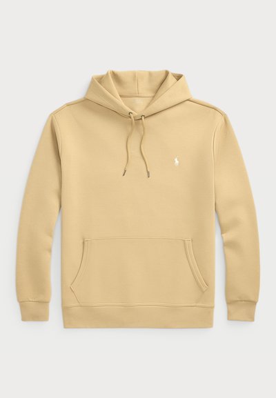 Huvtröja i ljusbeige, blandning av bomull. Har en känguruficka, justerbara dragkedjor och en liten logotyp på bröstet.