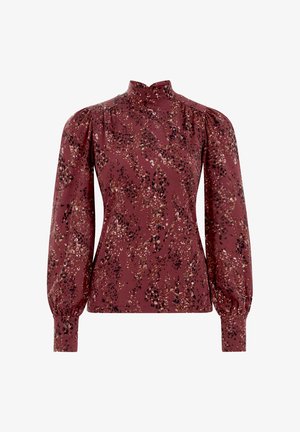 Bordo palaidinė su aukštu kaklu ir pūstomis rankovėmis, kurios audinys išsiskiria smulkiu gėlių raštu, naudojant beige ir juodos spalvos tonus.