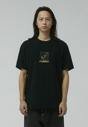 Black cotton t-shirt with short sleeves, featuring a yellow graphic print of a rocket and text “FORMER” on the front. Simple design.