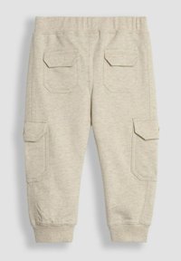 Helle beige Baumwoll-Cargo-Hosen mit elastischem Bund, seitlichen Taschen und gerippten Bündchen. Verfügt über zwei aufgesetzte Gesäßtaschen und eine dezente Struktur.