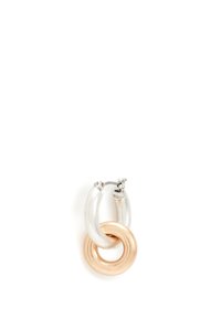 Two interlinked hoop earrings, one silver and one gold, featuring a smooth, shiny finish and a circular design with a textured accent.