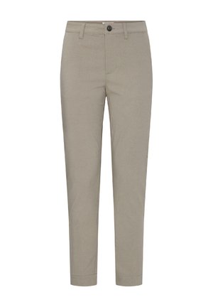 Beżowe spodnie o dopasowanym kroju, z szlufkami na pasek, zapięciem na guzik i suwak, przednimi kieszeniami i nogawkami o długości do kostek.
