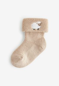 Beige strikket sok med ribbemanchet, prydet med et broderet fåredesign på folden. Blød tekstur, afrundet tå og ankel-længde pasform.