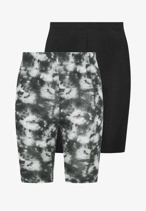 Zwei Paare hoch taillierte, eng anliegende Radshorts, eines in Schwarz und eines im schwarz-weißen Batikmuster, überlappend vor weißem Hintergrund.