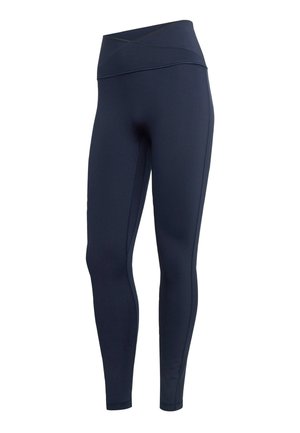 Tmavě modré legíny s vysokým pasem, překříženým pasem, celoplošně přiléhavými nohavicemi a plochými švy.