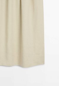 Rideau en lin beige suspendu droit avec de doux plis verticaux sur un fond blanc.