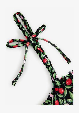 Czarny krawat z tkaniny z wzorem czereśni i liści, z zielonymi liśćmi i czerwonymi czereśniami, zdobiony falbaną na brzegu.