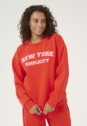 Felrood sweatshirt met ronde hals, lange mouwen en geribbelde boorden. Voorzien van witte tekst "NEW YORK SIMPLICITY" in een vet, contrasterend lettertype.