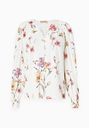 Blusa bianca a maniche lunghe con un motivo floreale in rosa, viola e giallo. Caratterizzata da una chiusura frontale con bottoni e dettagli arricciati sulle spalle. Tessuto liscio.
