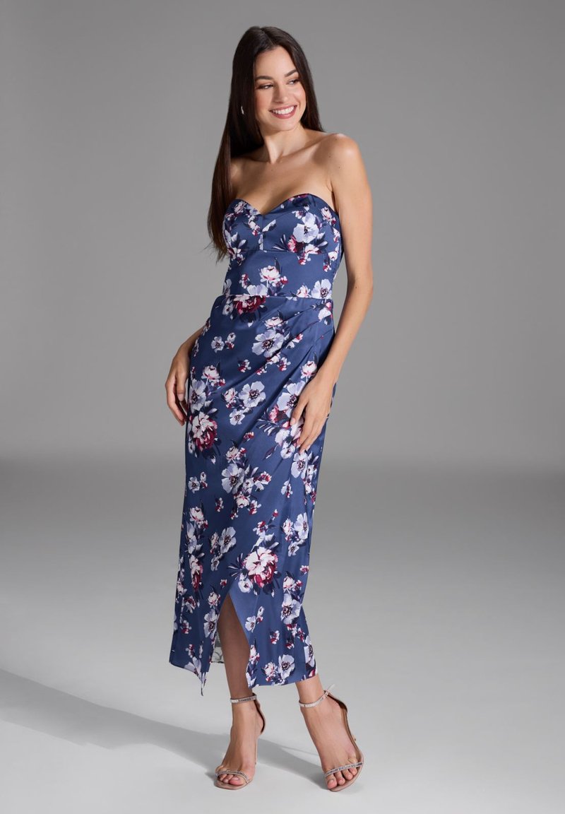 Vestido azul marino sin mangas con estampado floral, con un corsé ajustado y una abertura lateral, hecho de una tela suave. Acentuado por un diseño drapeado.