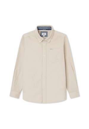 Beige langærmet skjorte med knapper, krave og brystlomme, med et lille mærke på lommen og blå foer inde i kraven.