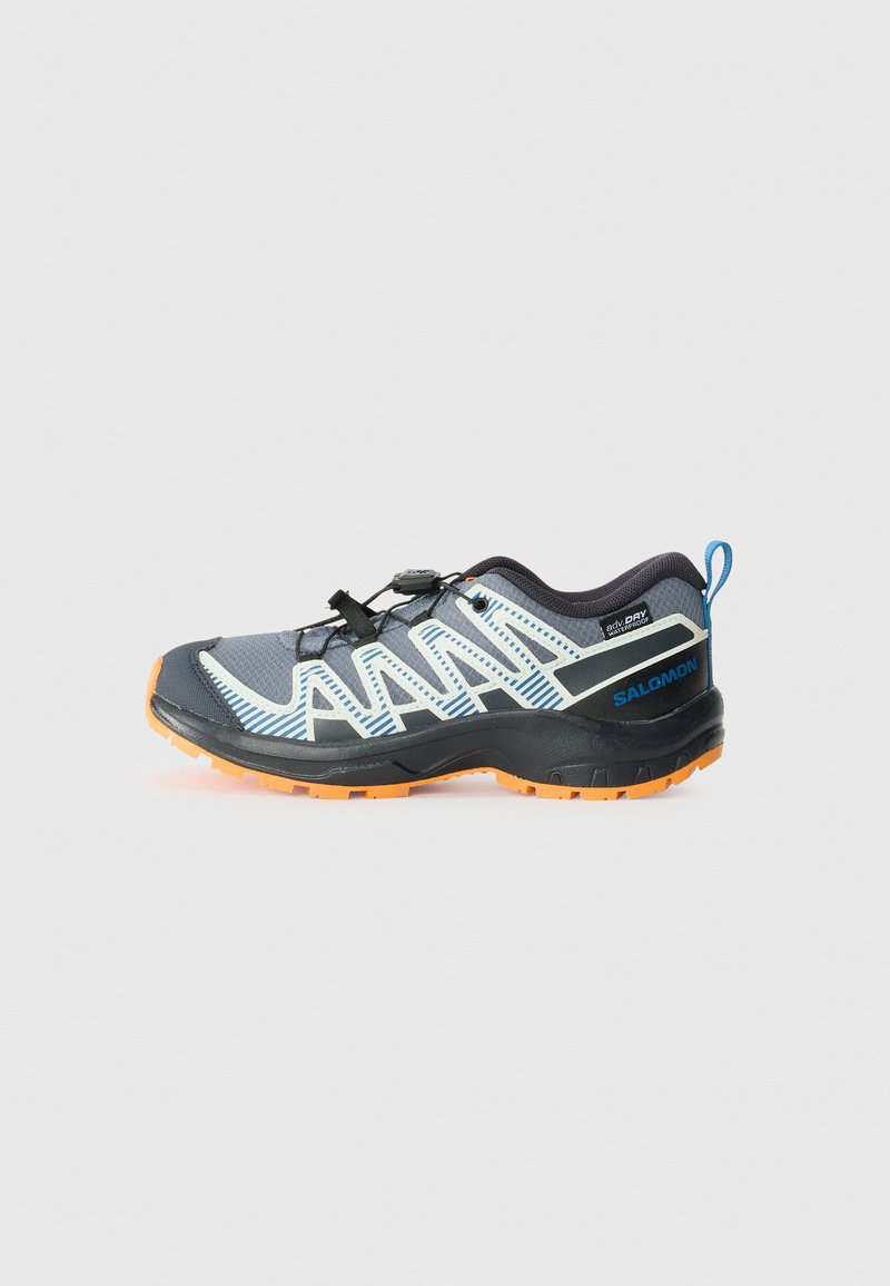 Black and gray athletic shoe with a textured upper, orange rubber sole, white and blue accent stripes, and a quick-lace system.