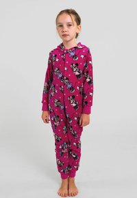 Tutina in pile rosa con un motivo a cartoni animati caratterizzato da personaggi con fiocchi, chiusura con zip intera e polsini alle maniche e alle caviglie.