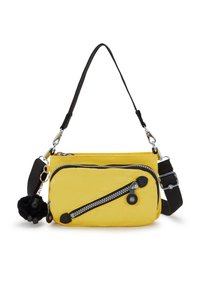 Keltainen nailonilaukku mustilla yksityiskohdilla, vinottainen vetoketjupussi, irrotettava karvainen pom pom -koriste ja säädettävä olkahihna. Sujuva pinta.