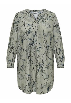Chemise à manches longues en tissu vert clair avec un imprimé botanique en bleu foncé. Dispose d'une fermeture à boutons à l'avant et d'un ourlet arrondi.