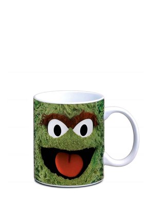 White mug with a green textured face featuring angry eyes, thick eyebrows, a wide open mouth, and a red tongue sticking out.