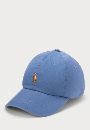 Světle modrá bavlněná baseballová čepice s zakřiveným kšiltem, na přední straně má malé vyšívané logo golfisty. Texturovaná tkanina.