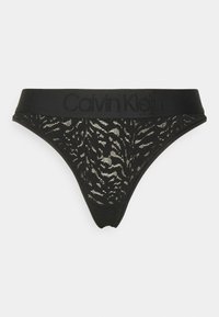 Zwarte Calvin Klein string met een doorschijnend kantontwerp met een subtiel zebrapatroon. Zwarte elastische tailleband met reliëflogo.