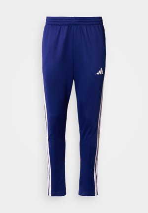 Ανδρικό αθλητικό παντελόνι σε ναυτικό μπλε πολυεστέρα, με λευκές πλαϊνές ρίγες και λογότυπο Adidas, με ελαστική μέση για άνεση.