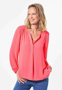 Korallenbluse aus leichtem Stoff mit langen Ärmeln und elastischen Bündchen, V-Ausschnitt und einem lässigen Schnitt mit sanften Falten.