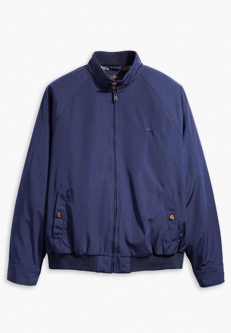 Veste bleu marine zippée avec col montant, poches latérales boutonnées et taille élastique, présentée sur fond blanc.