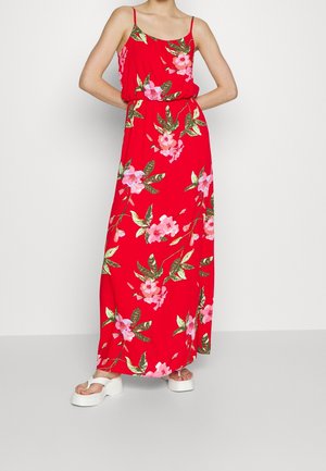 Czerwona długa sukienka w kwiatowy wzór z różowymi kwiatami i zielonymi liśćmi. Lekka tkanina, cienkie ramiączka i elastyczna talia.