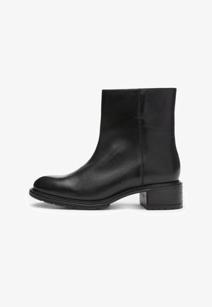 Black leather ankle boot with low block heel and round toe, smooth finish, side stitching, and rubber sole.