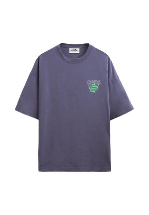 Purple oversized short-sleeve t-shirt with a small green snake and stylized text graphic on the left chest.