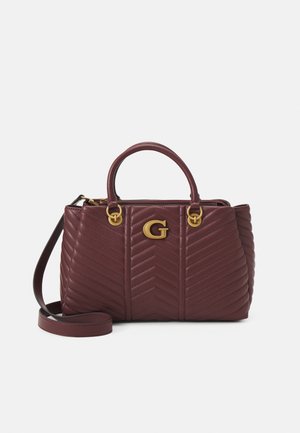 Dark red quilted leather handbag with top handles, gold "G" logo, and an adjustable shoulder strap on a white background.