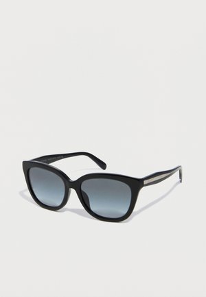 Black cat-eye sunglasses with gradient gray lenses and thin arms resting on a white surface.