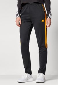 adidas Sportswear TIRO CUT 3 STRIPES TRACKPANTS - Treniņtērpa apakšdaļas - black/crew orange
