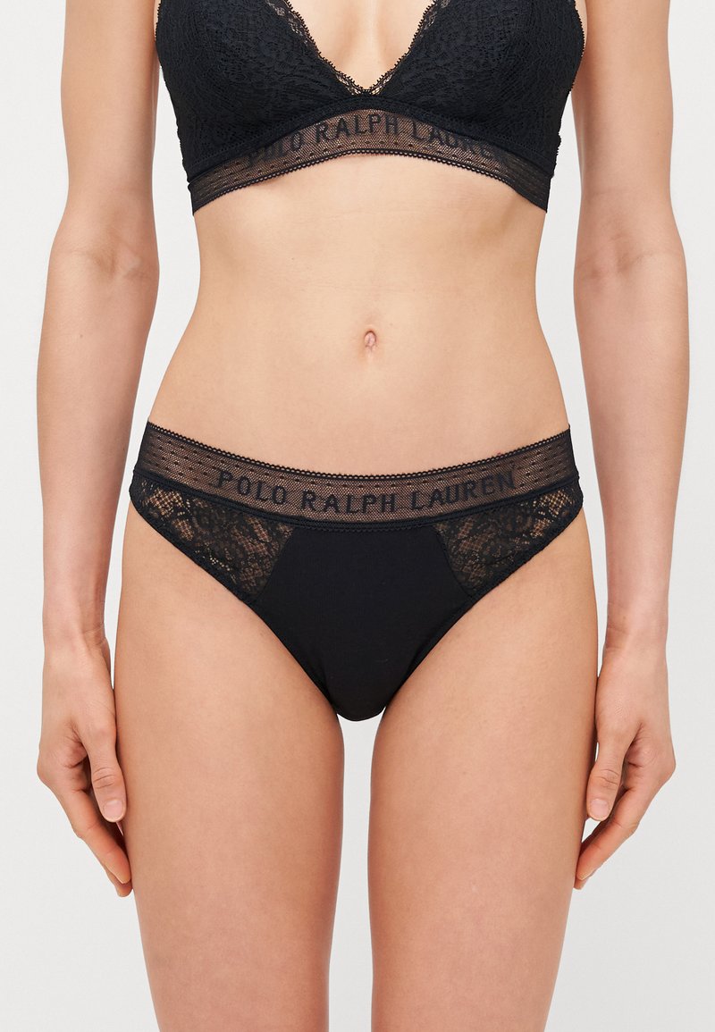 Black lace and soft fabric bralette and matching thong featuring a logo waistband, offering a blend of delicate texture and comfort.